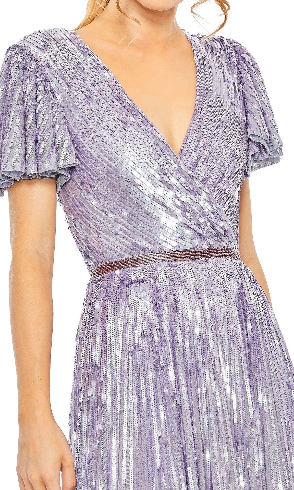Wearing the Long Formal Dress 5637 by Mac Duggal, featuring shiny lavender sequins, short pleated sleeves, a V-neckline, and a fitted waistband.